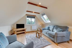 a living room with a couch and a tv at 1 Bed in Rhodes Minnis oc-ct041 in Lyminge +4 photos