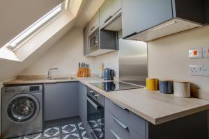 a kitchen with a washer and dryer on a counter at 1 Bed in Rhodes Minnis oc-ct041 in Lyminge