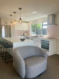 a kitchen with a couch in the middle of a room at Cozy, Modern, Quiet House in Westport