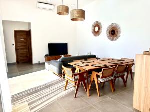 a living room with a table and a couch at Residence Azelina in Pointe aux Canonniers