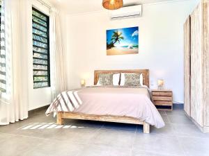 a bedroom with a bed and a window at Residence Azelina in Pointe aux Canonniers +13 photos