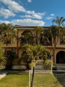 a building with palm trees in front of it at Hotel Condesa in Comayagua