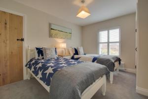 a bedroom with two beds and a window at 2 Bed in Holt oc-2148 in Holt