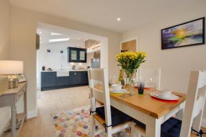 a kitchen and dining room with a table and chairs at 2 Bed in Holt oc-2148 in Holt