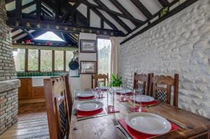 a dining room with a wooden table with red and white plates at 3 Bed in Bacton oc-711 in Bacton