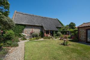 an old stone house with a garden in front of it at 3 Bed in Bacton oc-711 in Bacton