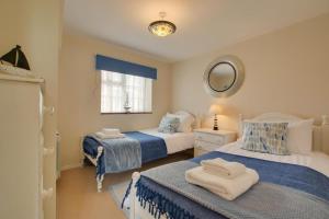 a bedroom with two beds and a mirror at 2 Bed in Cley oc-2165 in Cley next the Sea