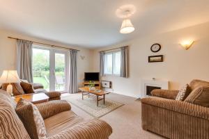 a living room with two couches and a table at 1 Bed in Ilfracombe oc-n2052 in Berrynarbor