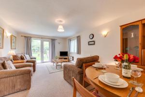 a living room with a table and a couch at 1 Bed in Ilfracombe oc-n2052 in Berrynarbor