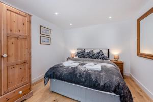 a bedroom with a large bed with two lamps on it at 1 Bed in Yapton oc-b32757 in Yapton