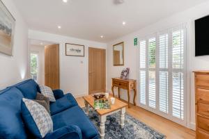 a living room with a blue couch and a table at 1 Bed in Yapton oc-b32757 in Yapton