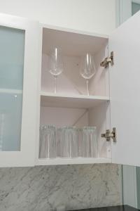 a white cabinet with wine glasses in it at Relax San Juan in San Juan +76 photos