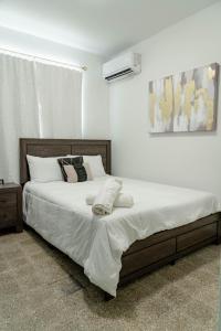 a bedroom with a large bed with white sheets and pillows at Relax San Juan in San Juan