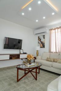 a living room with a white couch and a coffee table at Relax San Juan in San Juan