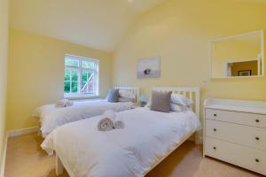 a bedroom with two beds with towels on them at 2 Bed in Walberswick oc-hhock in Walberswick