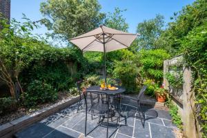 a patio with a table with an umbrella at 2 Bed in Walberswick oc-hhock in Walberswick
