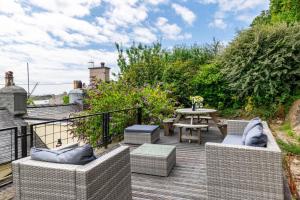 a patio with chairs and a table on a deck at 2 Bed in Pwllheli oc-30aber in Pwllheli