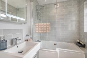 a white bathroom with a sink and a tub at 2 Bed in Aldborough oc-2257 in Thurgarton +17 photos