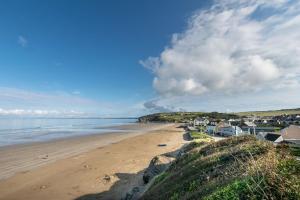 a view of a beach with houses and the ocean at 3 Bed in Broad Haven oc-t30529 in Broad Haven +13 photos