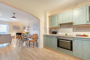 a kitchen with green cabinets and a table with chairs at 3 Bed in Broad Haven oc-t30529 in Broad Haven