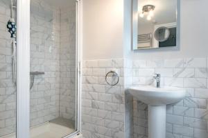 a white bathroom with a sink and a shower at 2 Bed in Southwold oc-eastgn in Southwold +8 photos