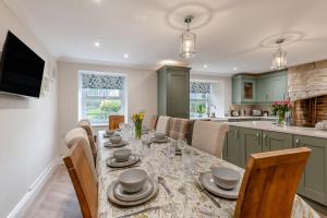 a kitchen and dining room with a table and chairs at 5 Bed in Biddlestone oc-b30105 in Alnham