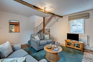 a living room with a couch and a tv at 2 Bed in Lavenham oc-f30054 in Lavenham