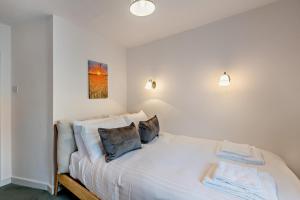 a bedroom with a white bed with two pillows at 2 Bed in Lavenham oc-f30054 in Lavenham