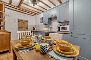 a kitchen with a wooden table with dishes on it at 2 Bed in Lavenham oc-t30056 in Lavenham