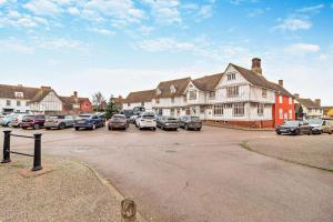 a group of cars parked in a parking lot at 2 Bed in Lavenham oc-t30056 in Lavenham +11 photos