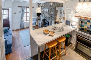 a kitchen with a island with a counter top and a fireplace at 2 Bed in Mumbles oc-l31146 in The Mumbles