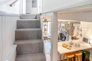 a tiny house with a staircase and a table at 2 Bed in Mumbles oc-l31146 in The Mumbles +12 photos