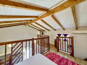 a room with wooden ceilings and a staircase with stained glass windows at Bungalows Arc en Ciel in Sainte-Anne +17 photos