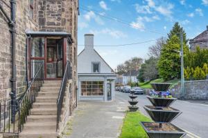 a brick building with stairs leading up to a store at 3 Bed in Wooler oc-m31820 in Wooler