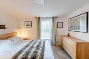 a bedroom with a bed and a dresser and a window at 3 Bed in Wooler oc-m31820 in Wooler