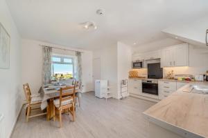 a kitchen and dining room with a table and chairs at 3 Bed in Clachan oc-h32242 in Clachan