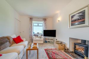 a living room with a couch and a fire place at 3 Bed in Clachan oc-h32242 in Clachan