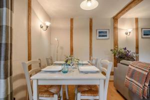 a white table with white chairs and a white table sidx sidx sidx at 2 Bed in Rumburgh oc-dgf in Rumburgh +8 photos