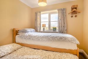 two beds in a bedroom with a window at 2 Bed in Halesworth oc-rect in Halesworth