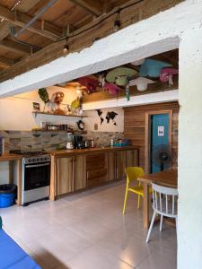 a kitchen with wooden cabinets and a table and chairs at Boho Pelicano in Bocas Town