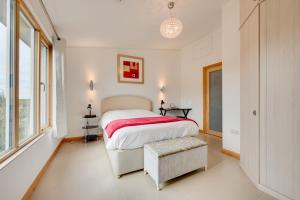 a white bedroom with a large bed and a window at 2 Bed in Stelling Minnis oc-ek715 in Lyminge