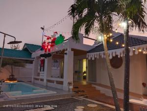 a house with a christmas decoration on it at แสงจันทร์พลูวิลล่าระยอง in Ban Thung Haeo +9 photos