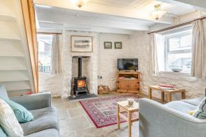 a living room with a couch and a fireplace at 2 Bed in Swansea oc-hh403 in Llanmadoc