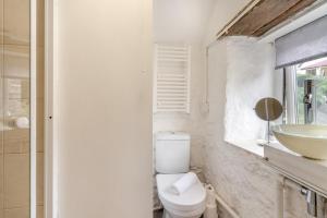 a white bathroom with a toilet and a sink at 2 Bed in Swansea oc-hh403 in Llanmadoc +22 photos