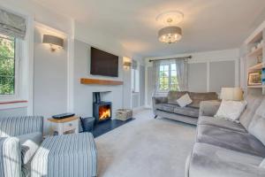 a living room with a couch and a fireplace at 5 Bed in Mundesley oc-2189 in Mundesley