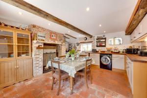 a kitchen with a table and chairs and a brick wall at 2 Bed in Colkirk oc-1397 in Colkirk