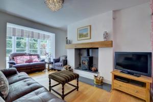 a living room with a couch and a tv at 4 Bed in Lynmouth oc-marins in Barbrook