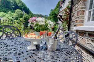 a table with a bowl of food and glasses on it at 4 Bed in Lynmouth oc-marins in Barbrook