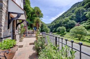 a house with a fence and a view of a river at 4 Bed in Lynmouth oc-marins in Barbrook