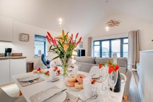 a kitchen and living room with a table with food at 2 Bed in Westward Ho oc-idleho in Northam